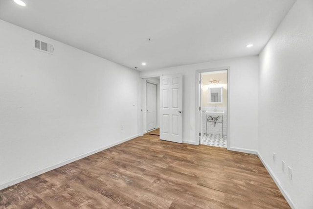 unfurnished room with wood-type flooring