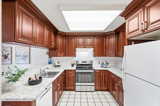 kitchen with sink, white appliances, light stone counters, light tile patterned flooring, and decorative backsplash