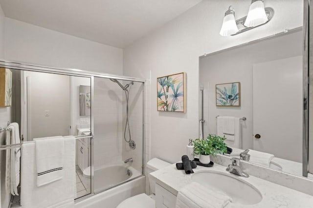 full bathroom with vanity, shower / bath combination with glass door, and toilet