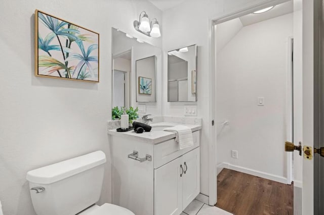 bathroom featuring hardwood / wood-style flooring, vanity, and toilet