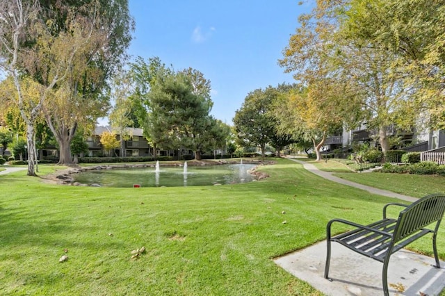 surrounding community featuring a water view and a yard