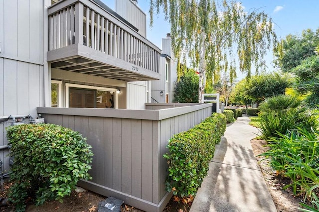 view of side of property with a balcony