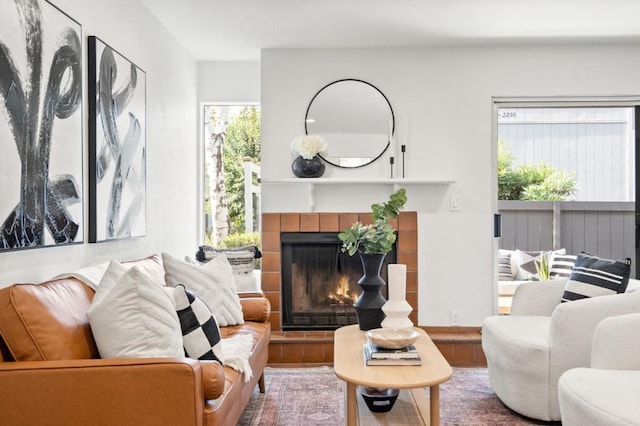 living room featuring hardwood / wood-style flooring, a fireplace, and a wealth of natural light