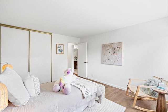 bedroom with hardwood / wood-style floors and a closet