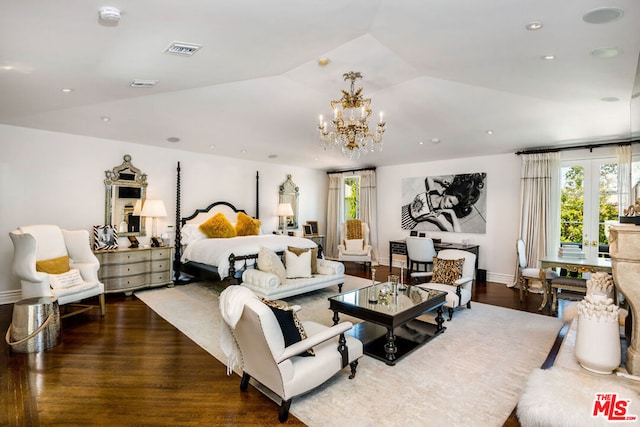 bedroom featuring lofted ceiling, french doors, dark hardwood / wood-style flooring, and an inviting chandelier