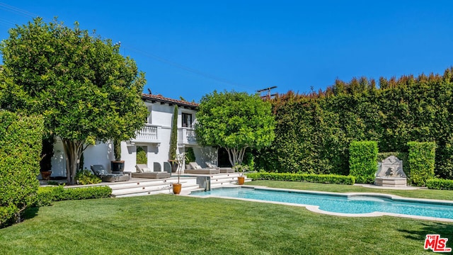 view of pool featuring a patio area and a yard