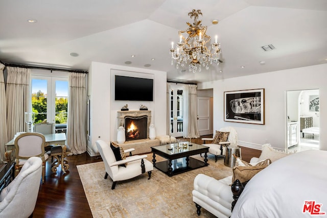 living room with hardwood / wood-style floors, vaulted ceiling, french doors, and an inviting chandelier