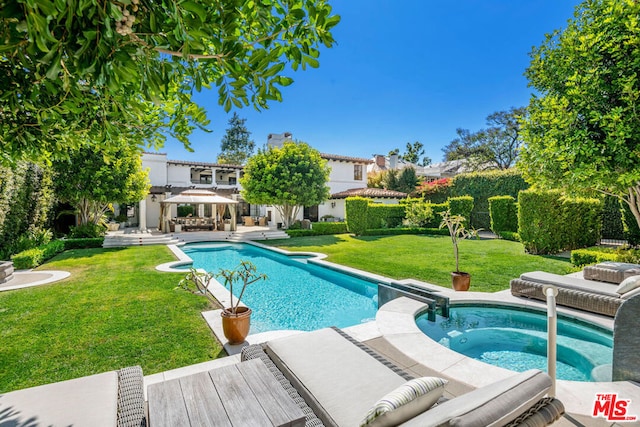 view of swimming pool featuring an in ground hot tub, a lawn, and a patio