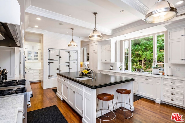 kitchen featuring a kitchen island, dark hardwood / wood-style flooring, white cabinets, and sink