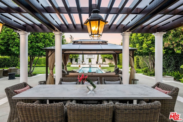 view of patio featuring a gazebo, a bar, and a pergola