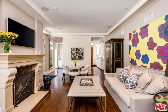 living room with dark hardwood / wood-style flooring and crown molding