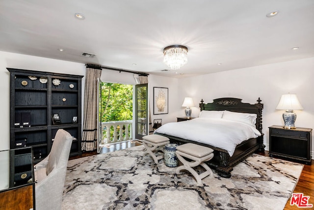 bedroom with a chandelier and hardwood / wood-style flooring