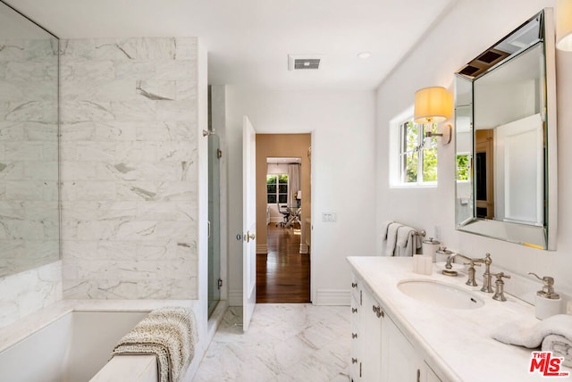 bathroom with walk in shower and vanity