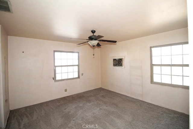 unfurnished room with ceiling fan and carpet