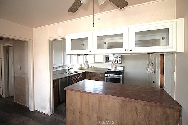 kitchen with sink, ceiling fan, appliances with stainless steel finishes, white cabinets, and dark hardwood / wood-style flooring