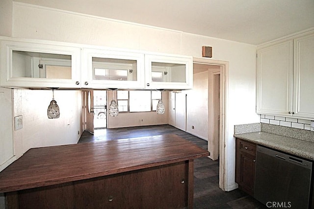 kitchen with white cabinets, dark hardwood / wood-style floors, dishwashing machine, and backsplash