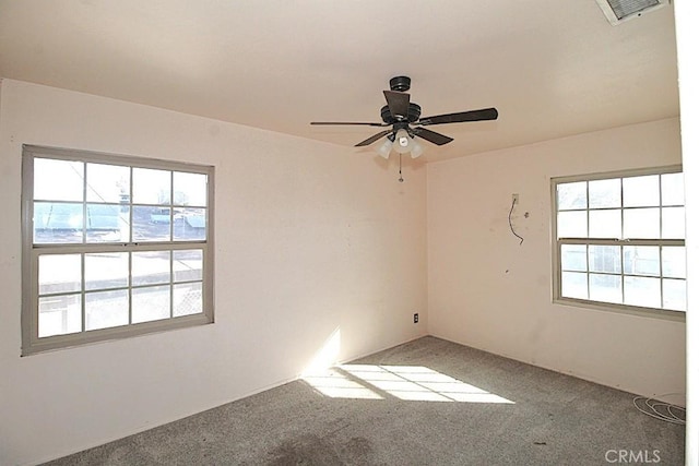 carpeted spare room featuring ceiling fan