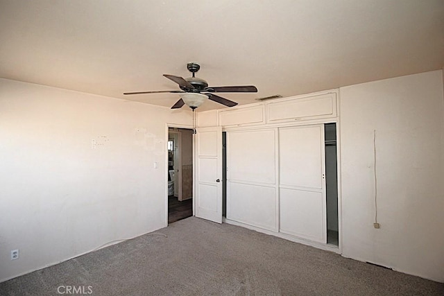 unfurnished bedroom with light carpet, a closet, and ceiling fan