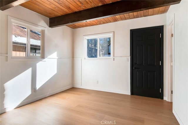 entryway with wood ceiling, beamed ceiling, and light wood-type flooring