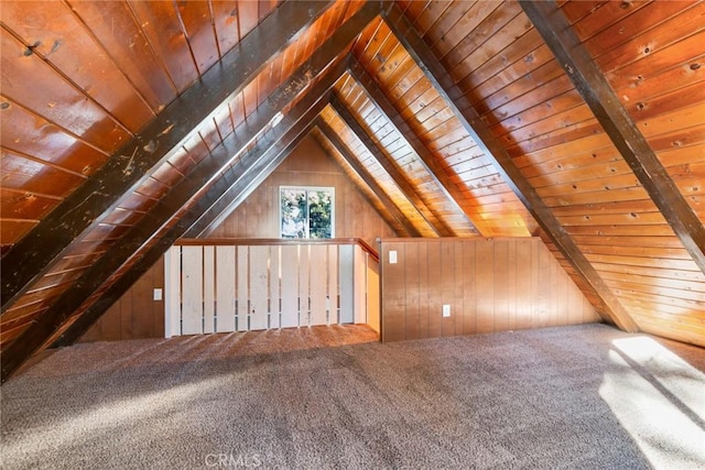 additional living space featuring vaulted ceiling with beams, carpet flooring, wood ceiling, and wooden walls