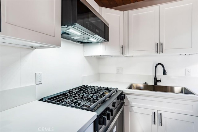 kitchen with white cabinets, sink, and stainless steel range with gas stovetop