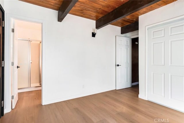 unfurnished bedroom with light hardwood / wood-style floors, wooden ceiling, and beamed ceiling