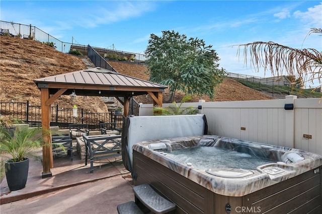 view of patio featuring a gazebo and a hot tub