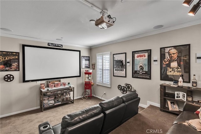 carpeted home theater featuring ornamental molding