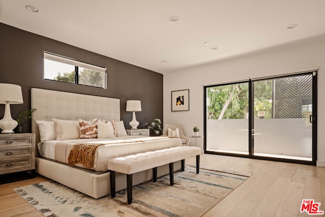 bedroom featuring access to outside and light wood-type flooring