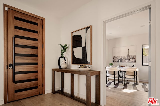 hallway with light hardwood / wood-style flooring