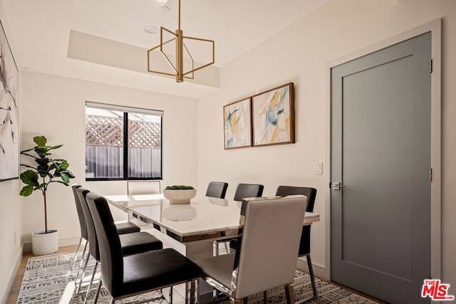 dining room with hardwood / wood-style flooring and a notable chandelier