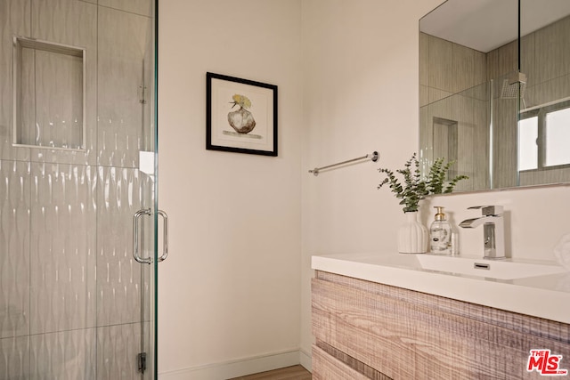 bathroom featuring vanity, a shower with door, and hardwood / wood-style floors