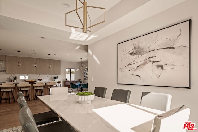 dining area featuring dark wood-type flooring