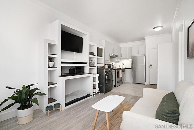 living room featuring built in features, crown molding, and light hardwood / wood-style flooring