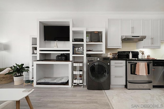 laundry room featuring light hardwood / wood-style floors, ornamental molding, and washer / clothes dryer