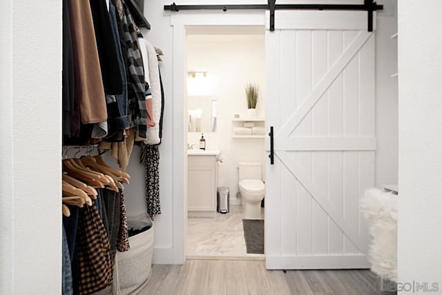 bathroom featuring hardwood / wood-style floors, toilet, and vanity