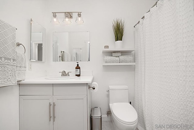 bathroom featuring toilet and vanity