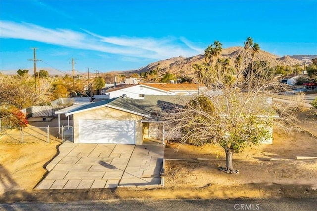 exterior space with a garage and a mountain view