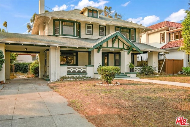 view of front facade with a porch and a carport