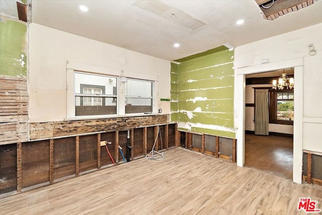 interior space featuring hardwood / wood-style floors and an inviting chandelier