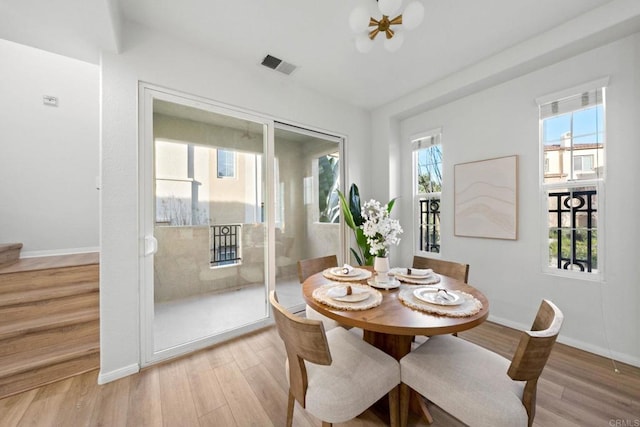 dining area with ceiling fan and light hardwood / wood-style flooring