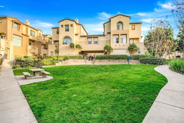 view of home's community featuring a lawn