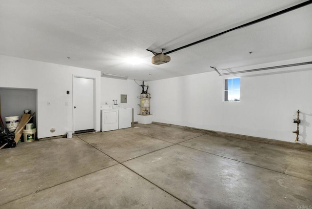 garage featuring a garage door opener, water heater, and independent washer and dryer