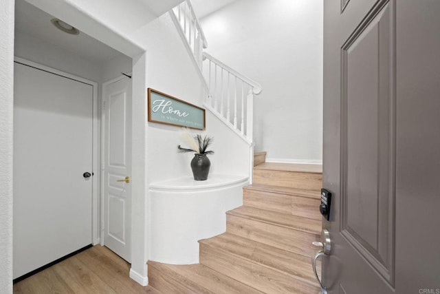 stairs with hardwood / wood-style floors