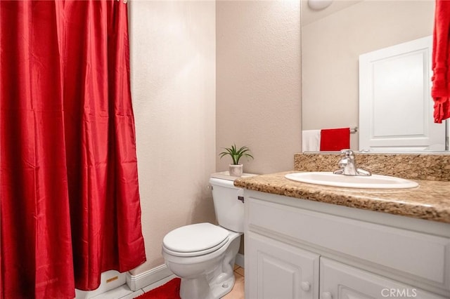 bathroom with toilet and vanity