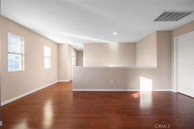 spare room with dark hardwood / wood-style floors