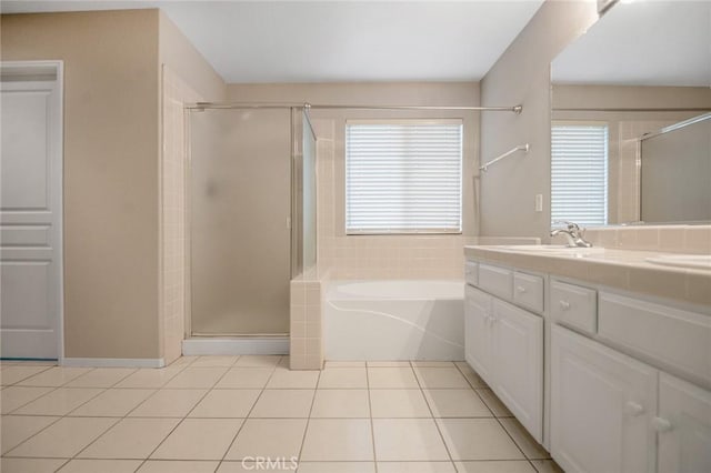 bathroom featuring vanity, tile patterned flooring, and plus walk in shower