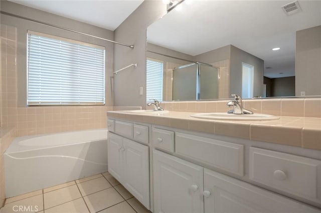 bathroom featuring vanity, independent shower and bath, and tile patterned flooring