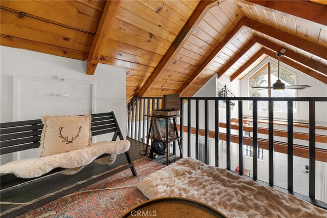 sitting room featuring ceiling fan, wood ceiling, and vaulted ceiling with beams