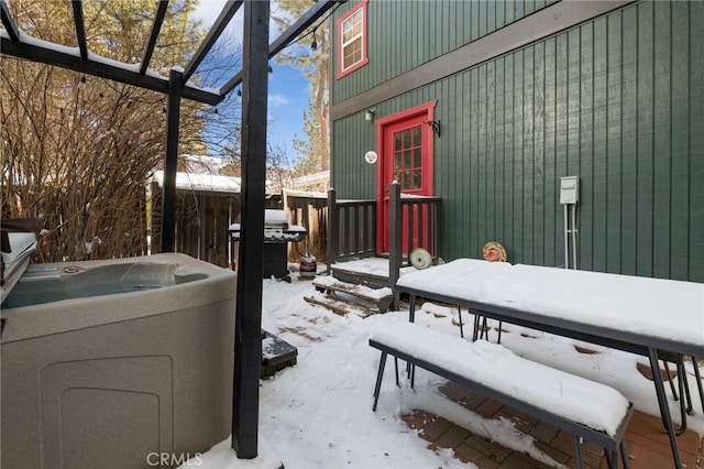 snow covered patio featuring a grill and a hot tub